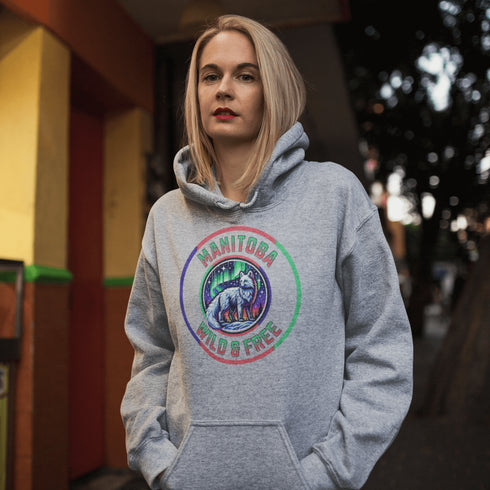 Unleash your wild side with our Manitoba – Wild & Free hoodie, featuring an enchanting graphic of an arctic fox beneath the dazzling northern lights.